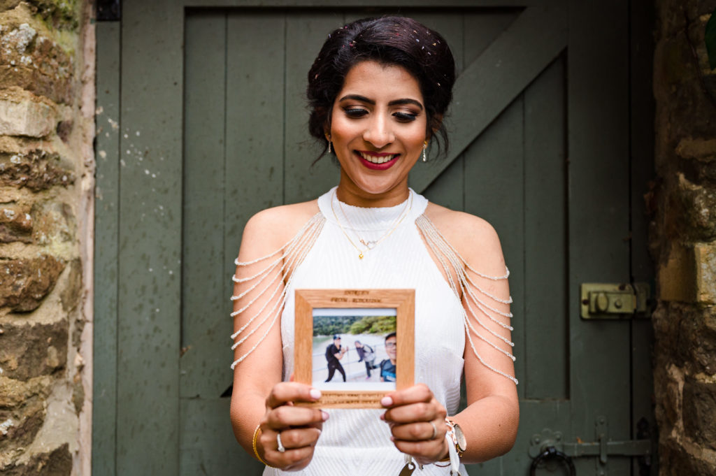 Bride with photo frame at Oakham Registry office