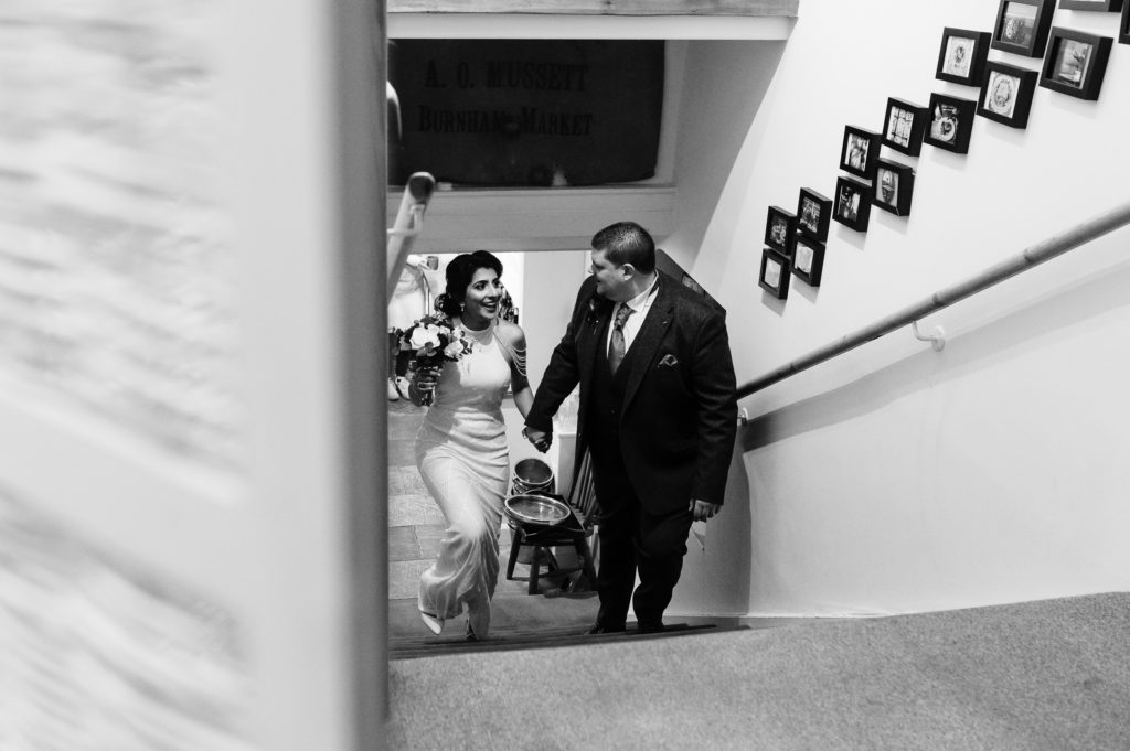 Bride and Groom walking up stairs at Hitchens Barn