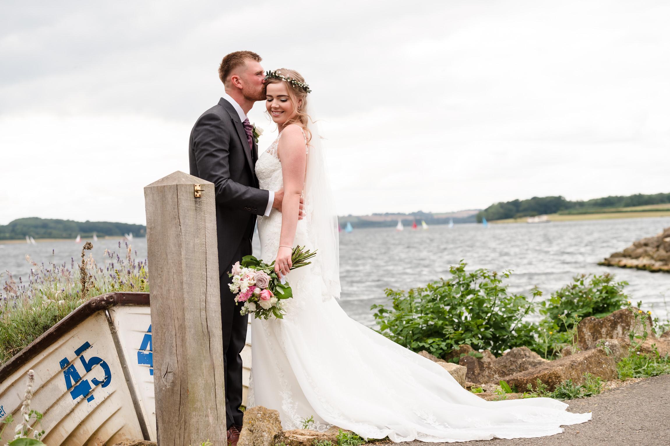 bride and groom portraits near boat at normanton church