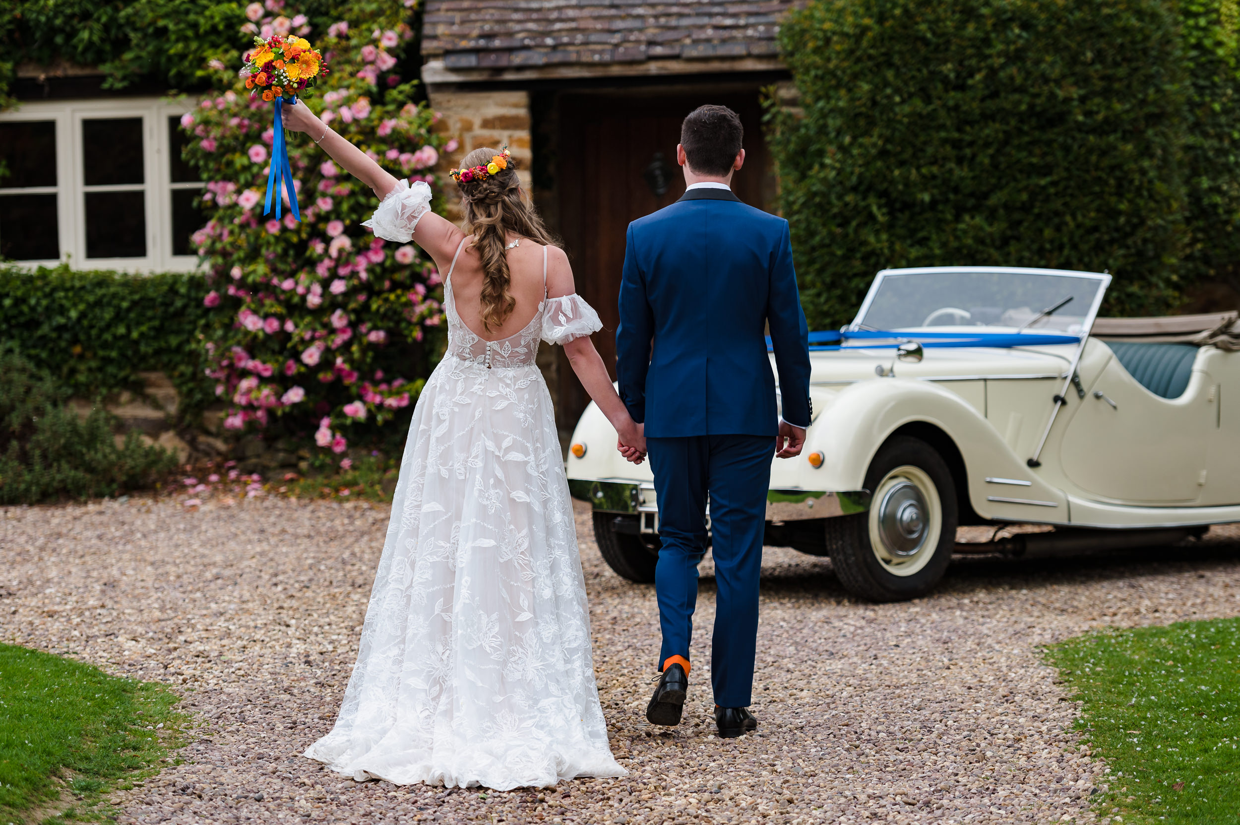 Bride throwing her arm in the air at dodmoor house