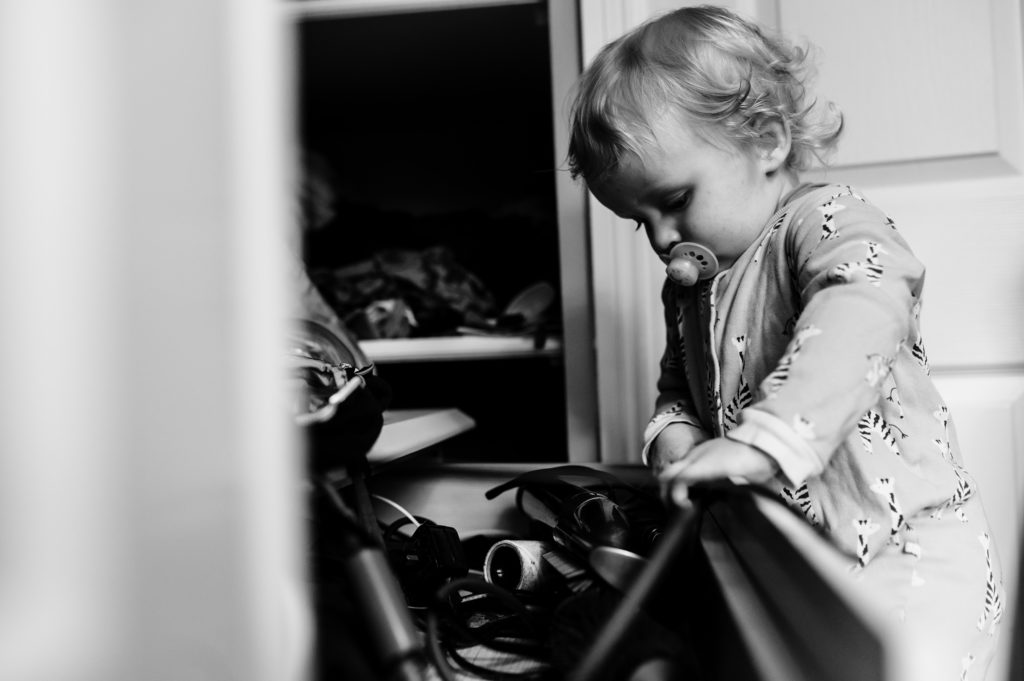 little boy looking in a drawer