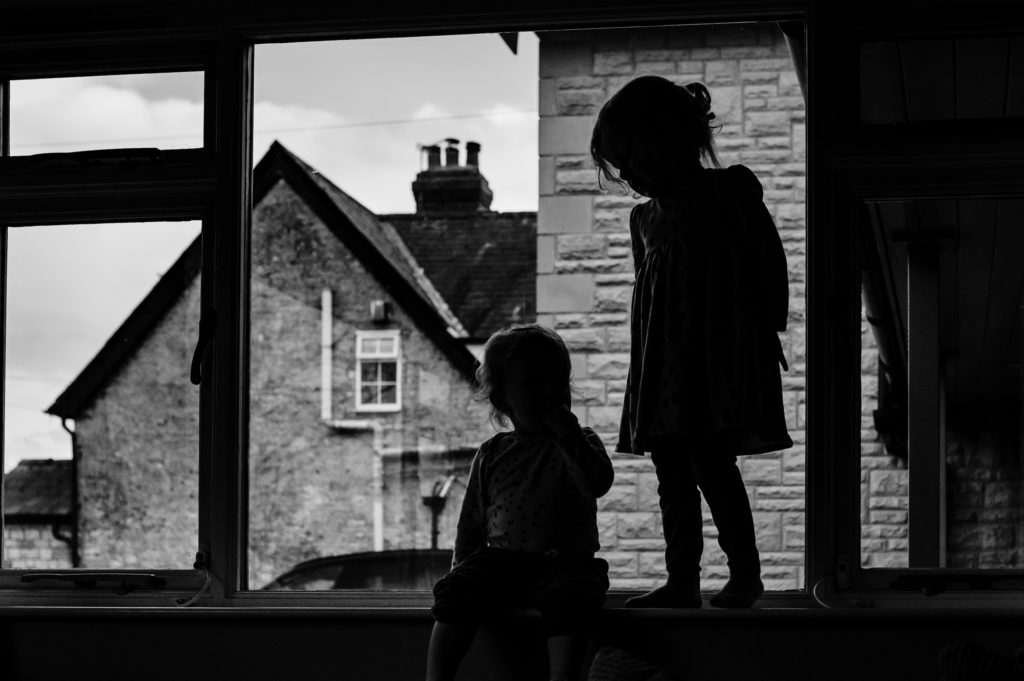 two children silhouetted in the window