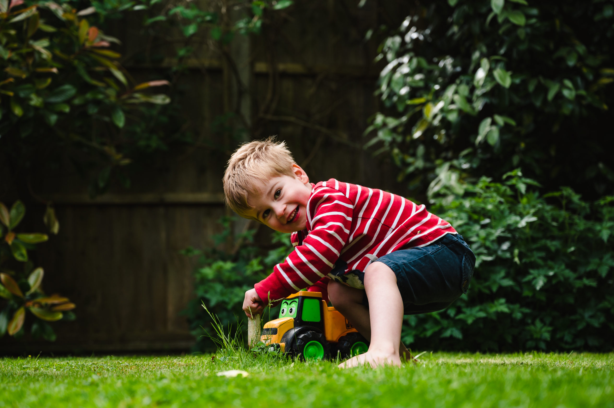boy playing with tractor in garden family photoshoot rutland