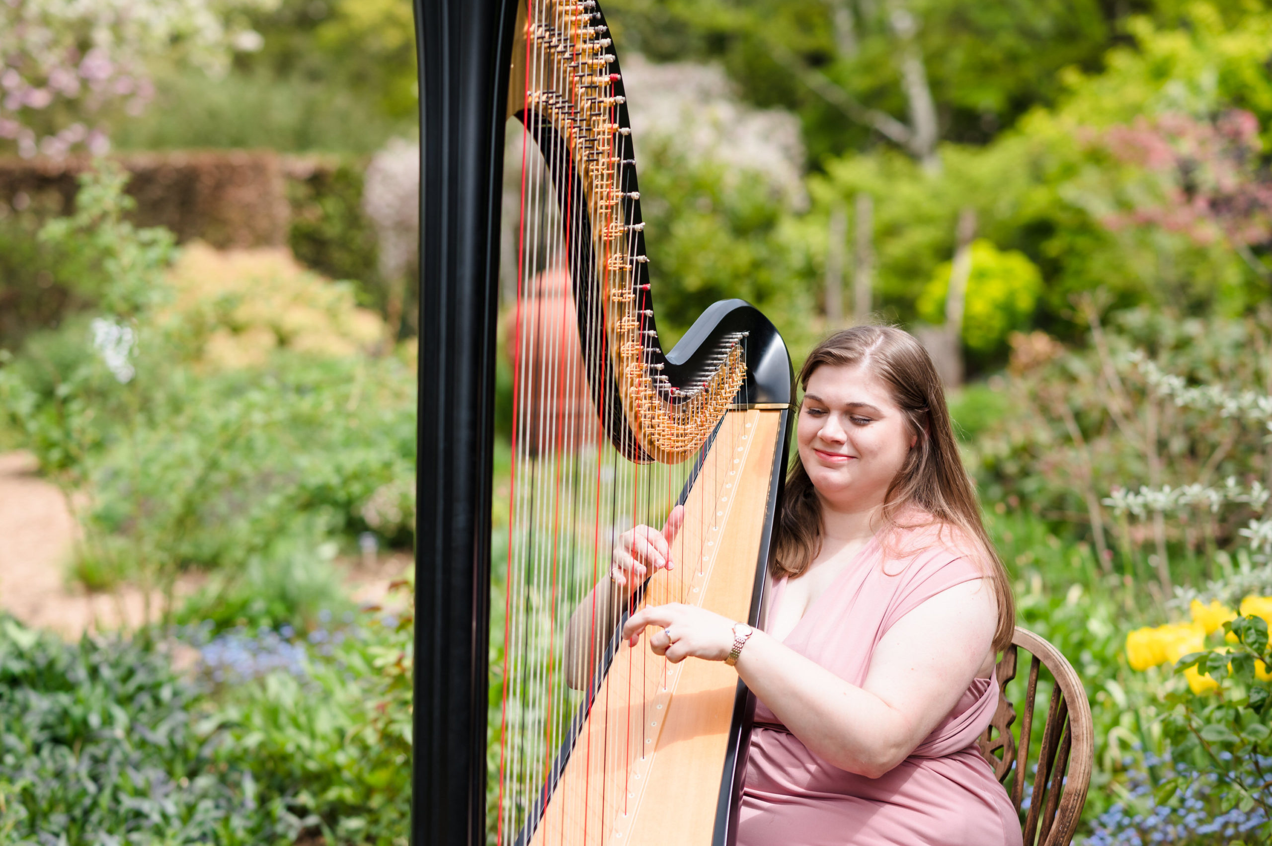 Harriet Flather playing the harp at Barnsdale Gardens Rutland