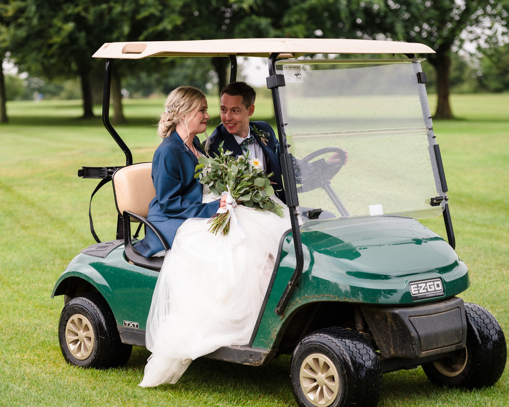 bride and groom on golf buggy at Rutland Water Golf Course