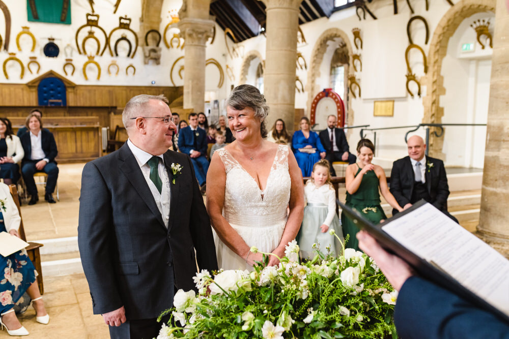 bride and groom at the top of the aisle at oakham castle
