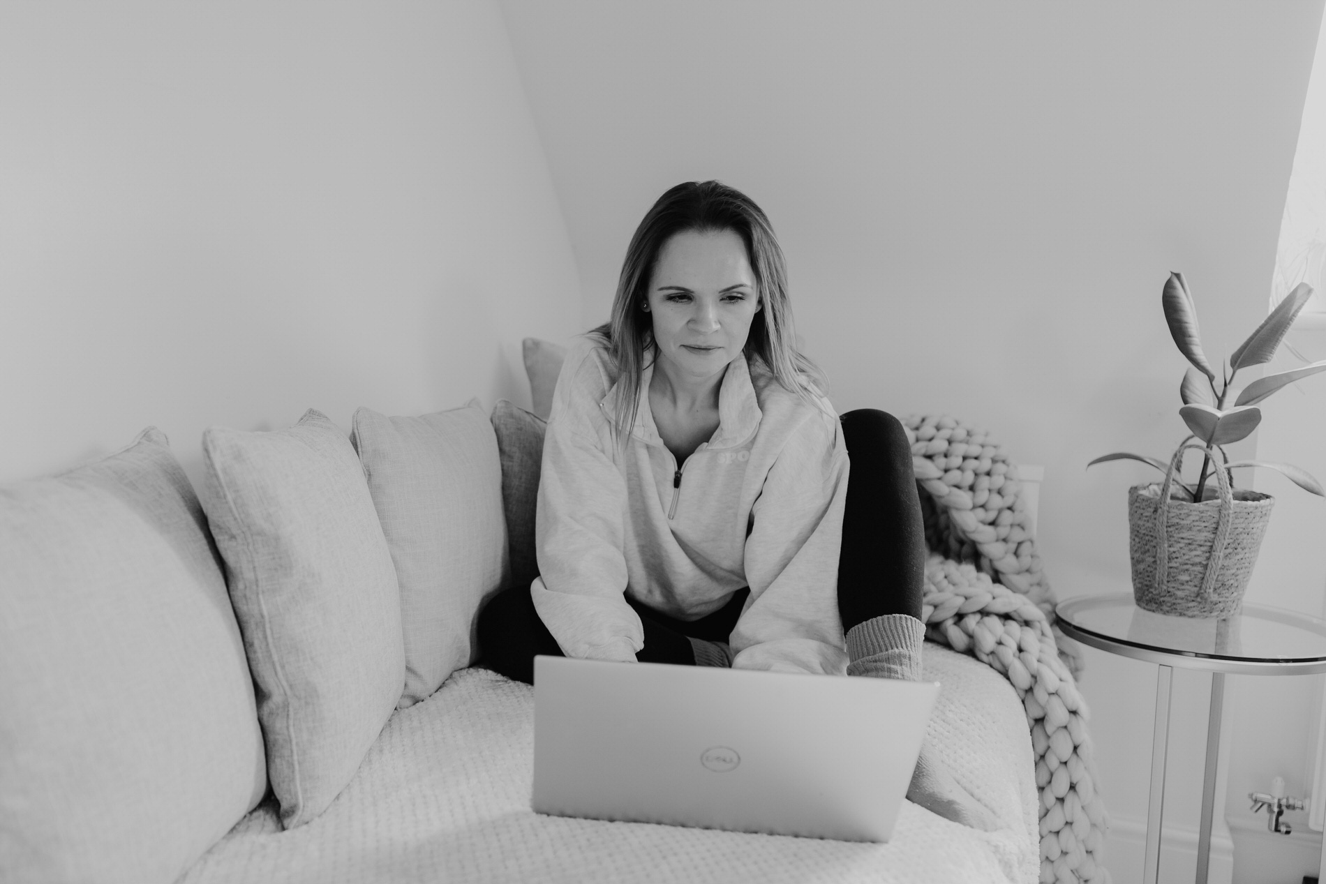 photo of Amanda Forman sat on sofa with laptop