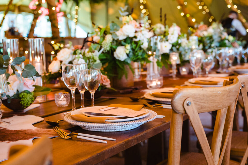 photo of the table set up with lamps, cow hides and flowers at dibbins wood