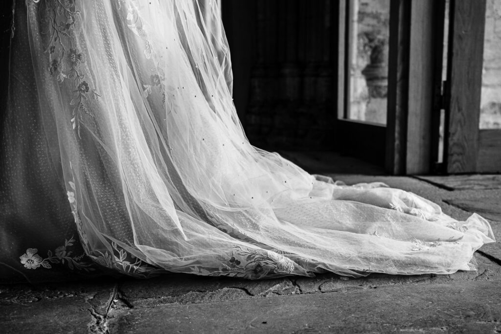 close up of the brides dress at Peterborough cathedral wedding