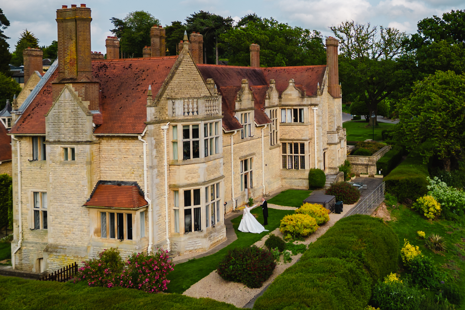 Drone shot of bride and groom outside honeymoon suite at rutland hall