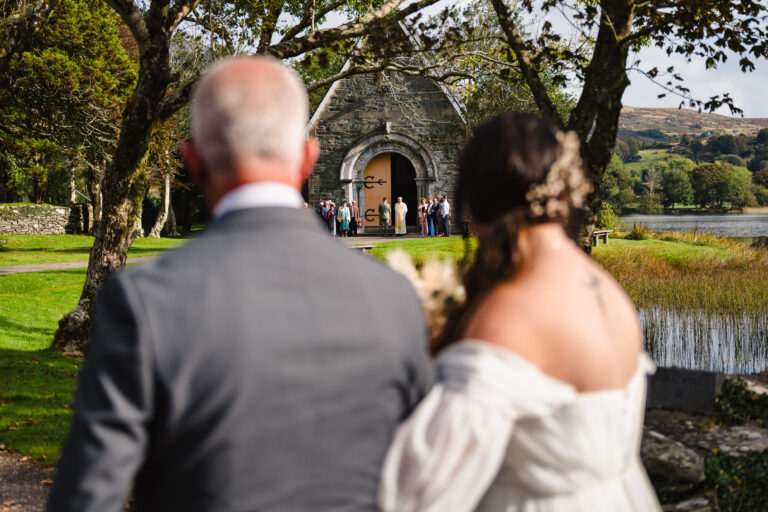 Bride arriving with her father at gougan barra church Ireland